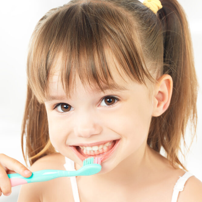 dental hygiene. happy little girl brushing her teeth